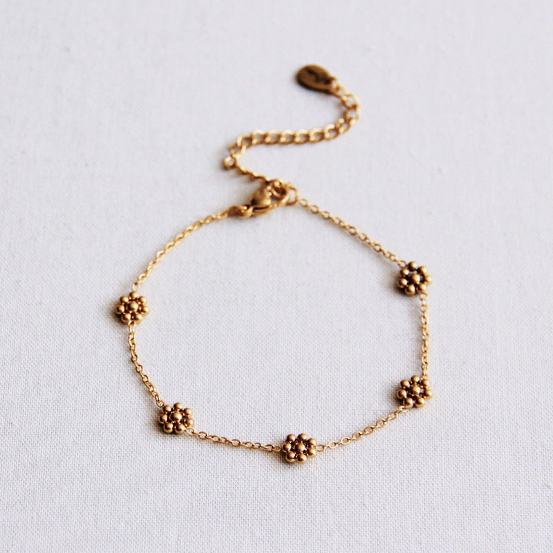 Roestvrij stalen armband met fijne madeliefjesbloem - goud