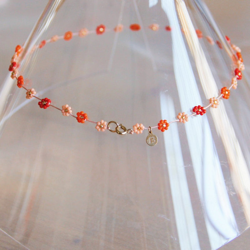 Ketting met madeliefjesbloem – Mix rood/roze